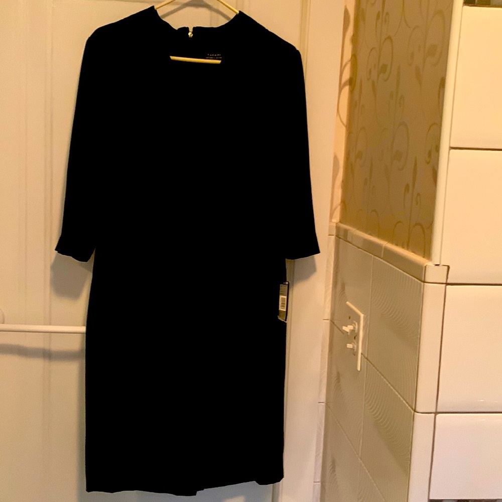 Beautiful never worn black 3/4 sleeve dress.It features flattering side ruching.